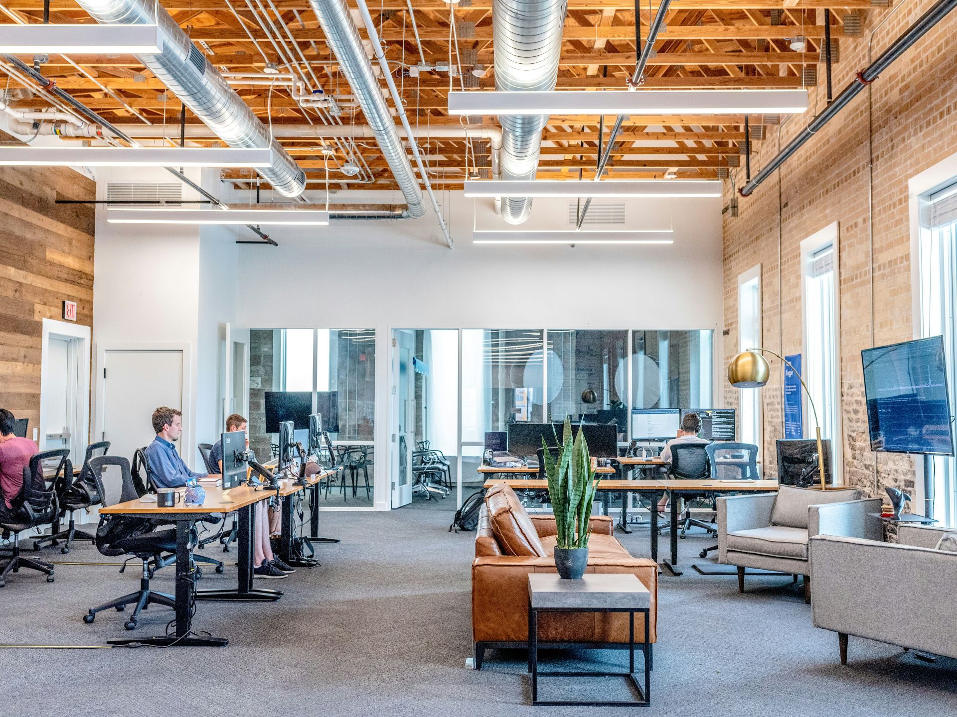 Open concept office with professionals working at desks.
