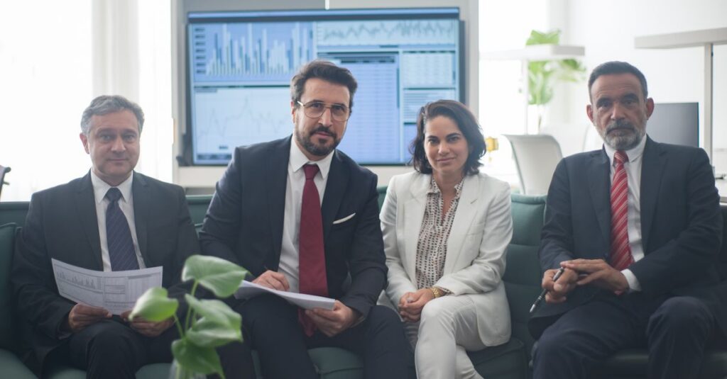 Professional team in corporate attire ready for a meeting, engaged in discussion.