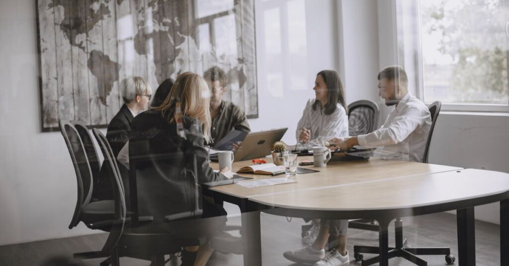 A diverse group of colleagues in a meeting in a modern office setting.