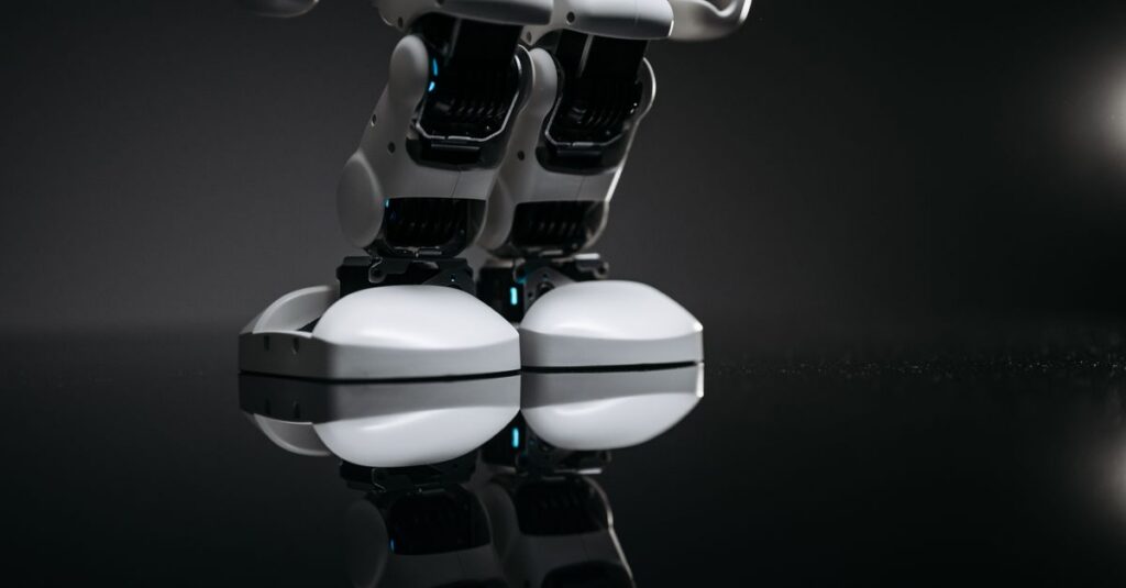 Close-up of robotic legs reflecting on a glossy surface in a studio setting.