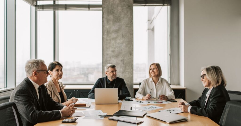 A diverse group of professionals engaged in a business meeting in a modern office.