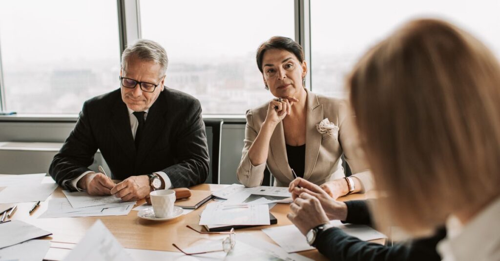 Business professionals in discussion during a meeting in a modern office setting.