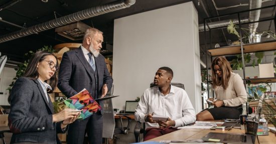 Diverse colleagues engaged in a business meeting in a contemporary office environment.