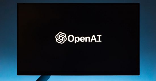 Minimalist display of OpenAI logo on a screen, set against a gradient blue background.